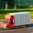Red box truck driving on a highway in daylight, with a blurred green background indicating motion.